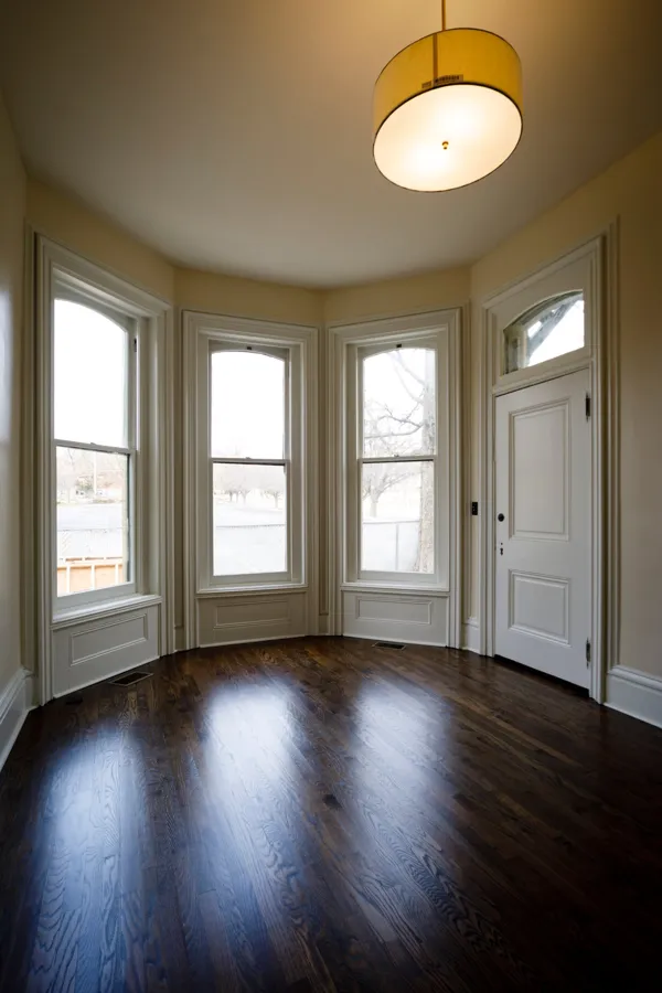 A three-window bay with paneled trim beneath each window