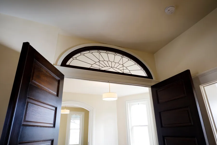 Close-up of the leaded glass fanlight above the oak doors