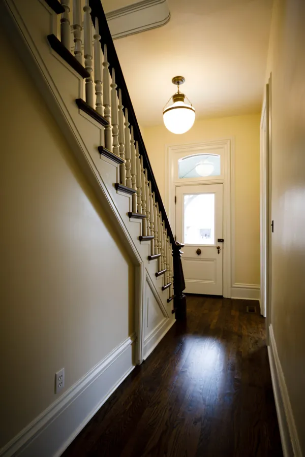 The side hall with the staircase and the front door with its transom