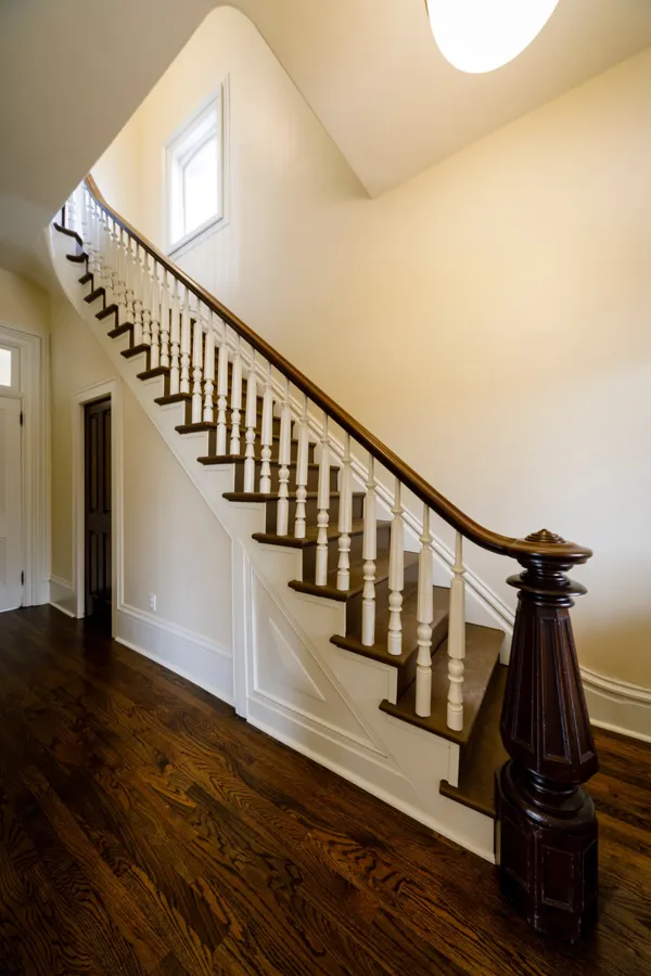 The original staircase with its fluted newel post and turned balusters